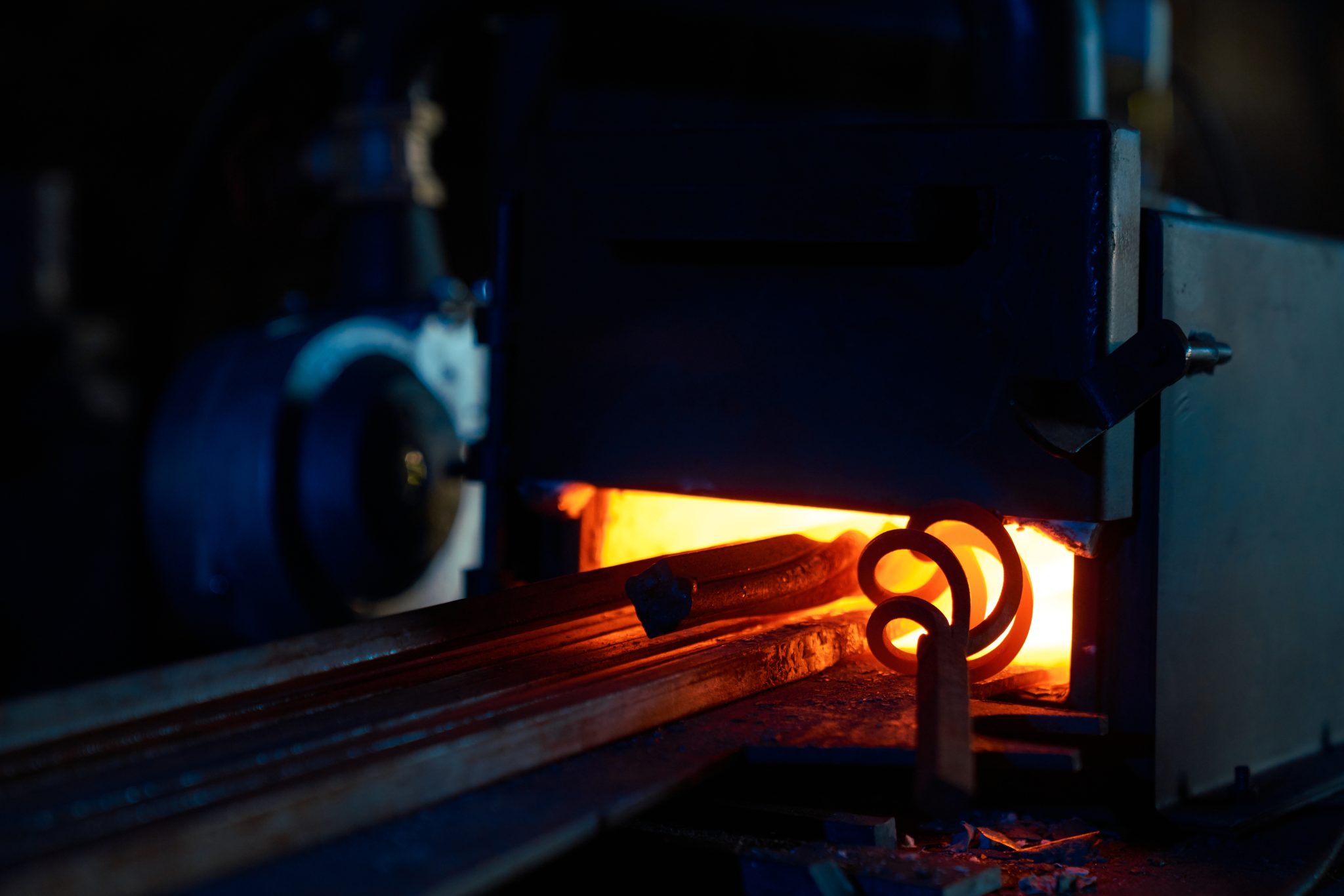 Close up of various pieces of iron heating inside forge furnace. Burning fire with steel. Preparation of metal for processing.